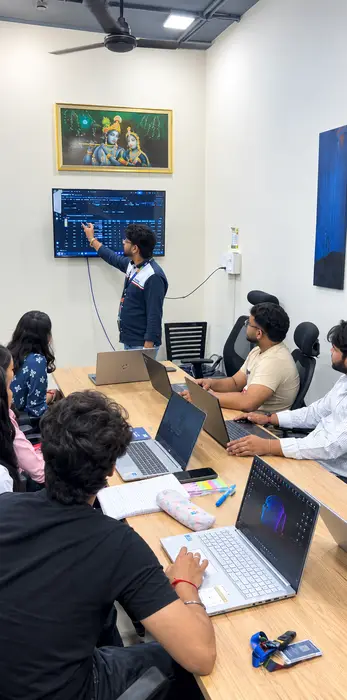 A trainer walking students through a data table on screen
