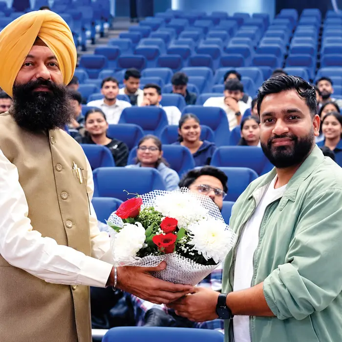 A welcome at a college talk, the audience behind