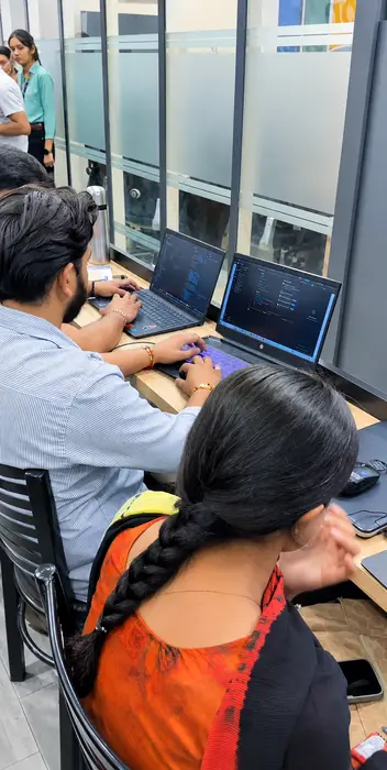 Two students coding side by side
