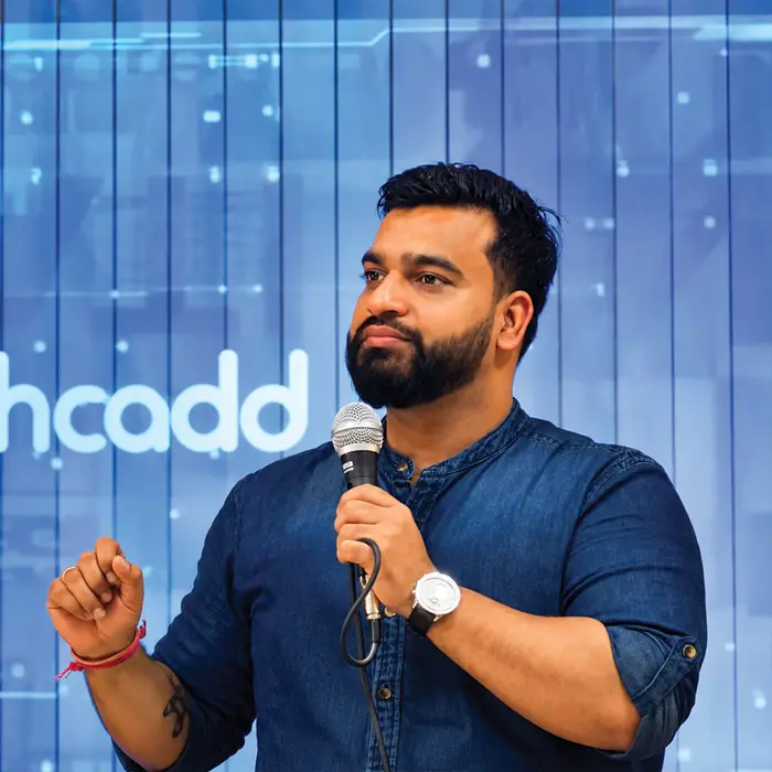 Speaking to students with the techcadd logo behind