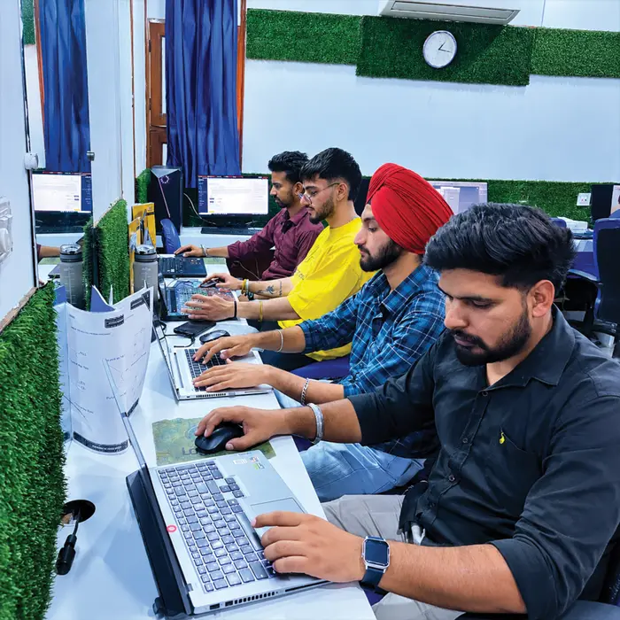 A row of students on their laptops in the lab