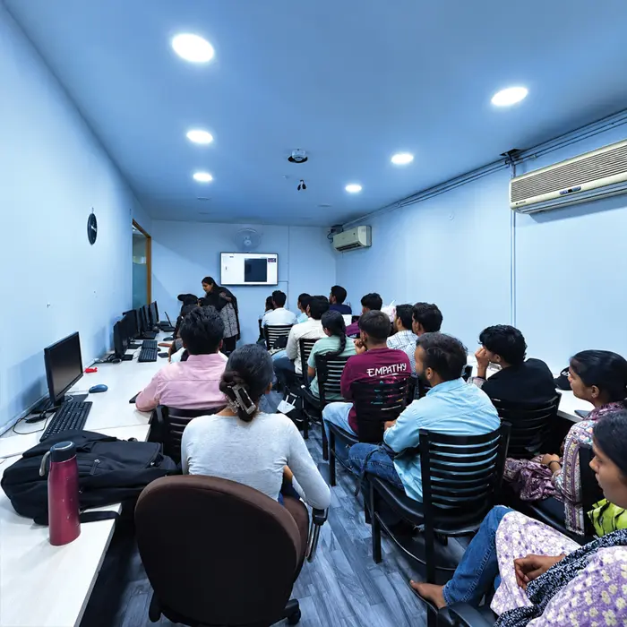 A class following a demo on the wall screen