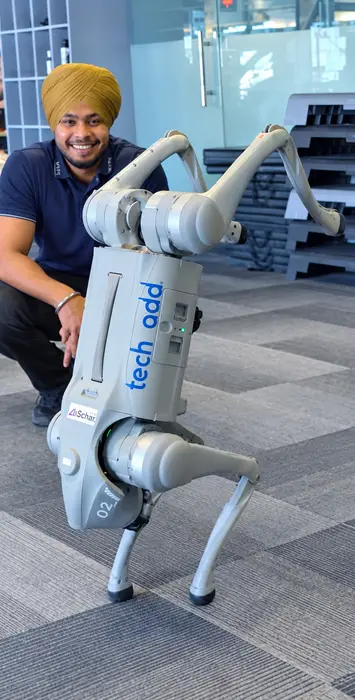 A trainer with the techcadd robot dog