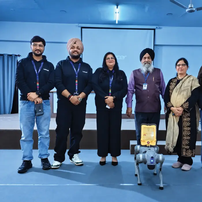 The techcadd team receiving an award, the robot dog in front