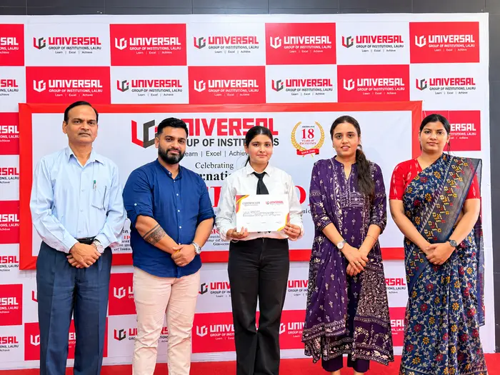 A student receiving a certificate at Universal Group of Institutions